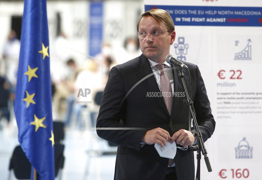 Boris Grdanoski European Commissioner for Neighborhood and Enlargement Oliver Varhelyi talks to the media in the presence of Austrian Federal Minister for EU Karoline Edstadler and North Macedonia's Prime Minister Zoran Zaev, after visiting the center for mass vaccination against COVID-19, at A1 Arena in Skopje, North Macedonia, on Tuesday, May 4, 2021. The European Union started delivering EU-funded coronavirus vaccines Tuesday to the Balkans, a region that wants to join the 27-nation bloc but where China and Russia have already been supplying the much-needed shots and making political gains. (AP Photo/Boris Grdanoski)