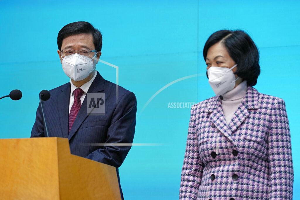 Kin Cheung Hong Kong Chief Executive John Lee, left, and convener of the Executive Council Regina Ip attend a news conference in Hong Kong, Tuesday, July 5, 2022. Lee said Tuesday in his first news conference since taking the reins that he will work towards legislating easing restrictions for travelers, but that it must be balanced with limiting the spread of the coronavirus so as not to overwhelm the healthcare system. (AP Photo/Kin Cheung)