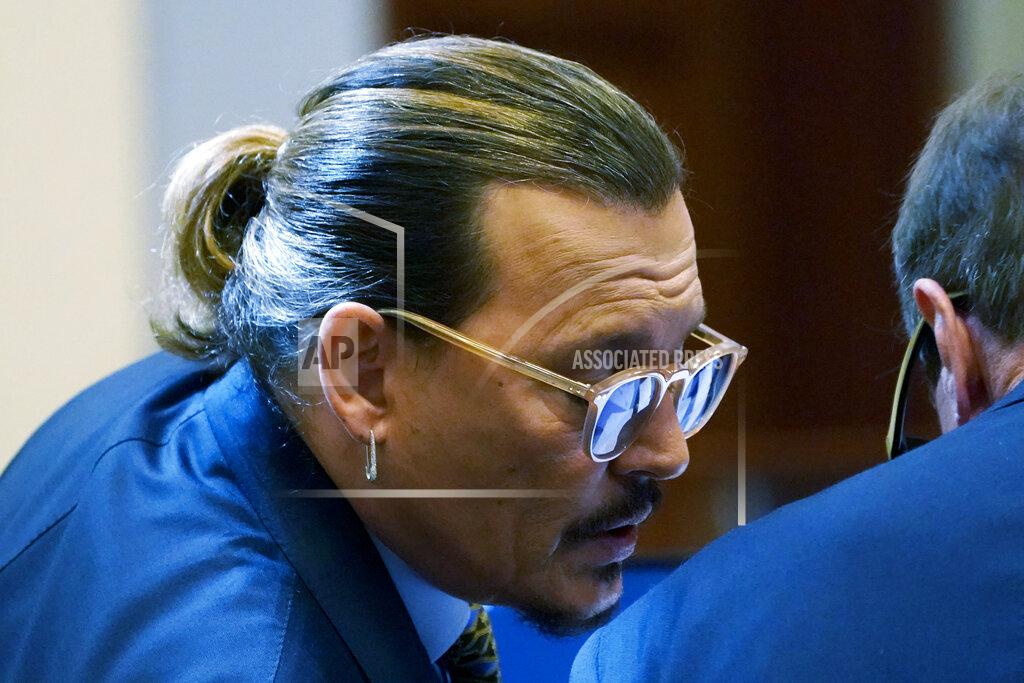 Steve Helber Actor Johnny Depp talks to his attorney Ben Chew, in the courtroom at the Fairfax County Circuit Courthouse in Fairfax, Va., Monday, May 23, 2022. Depp sued his ex-wife Amber Heard for libel in Fairfax County Circuit Court after she wrote an op-ed piece in The Washington Post in 2018 referring to herself as a "public figure representing domestic abuse." (AP Photo/Steve Helber, Pool)