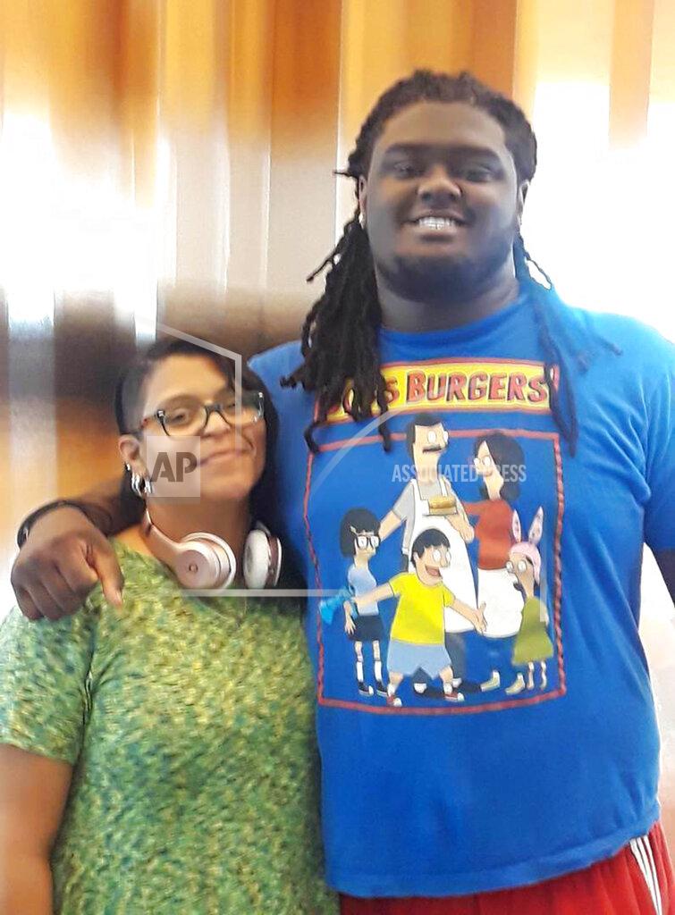 In this undated photo provided by Joanne Atkins-Ingram, Atkins-Ingram poses with her son Braeden Bradforth. An independent review of the heatstroke death of Bradforth, a 19-year-old football player who collapsed after the first day of conditioning practice at a Kansas community college, has found “a striking lack of leadership.” Bradforth, a 315-pound defensive lineman for Garden City Community College, was found unconscious on Aug. 1, 2018. The New Jersey native died that night. The report highlights a lack of oversight and a failure to assess athletes prior to the conditioning test, among other issues. (Courtesy Joanne Atkins-Ingram via AP)