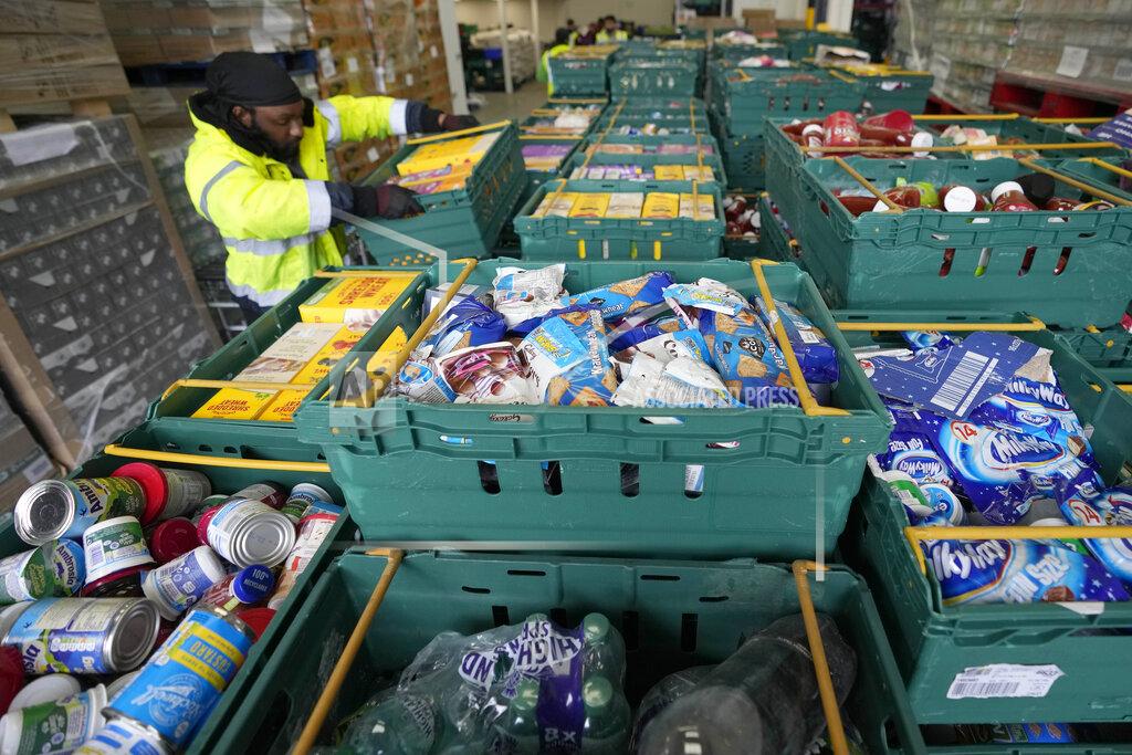 Frank Augstein A volunteer from the charity 'The Felix Project' collects food at their storage hub in London, Wednesday, May 4, 2022. Across Britain, food banks and community food hubs that helped struggling families, older people and the homeless during the pandemic are now seeing soaring demand. The cost of food and fuel in the U.K. has risen sharply since late last year, with inflation reaching the highest level in 40 years. (AP Photo/Frank Augstein)