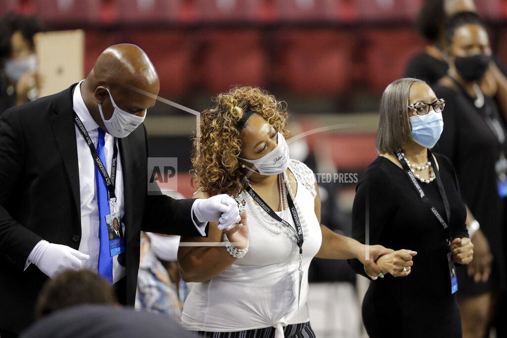 Brynn Anderson Mourners sing during the service for the late Rep. John Lewis, D-Ga., at Troy University on Saturday, July 25, 2020, in Troy, Ala. Lewis, who carried the struggle against racial discrimination from Southern battlegrounds of the 1960s to the halls of Congress, died Friday, July 17, 2020. (AP Photo/Brynn Anderson)