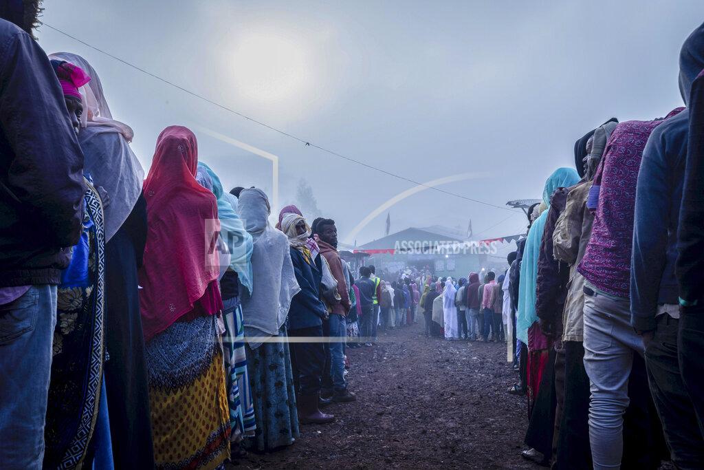 Mulugeta Ayene Ethiopians queue in the early morning to cast their votes in the general election, in Prime Minister Abiy Ahmed's home town of Beshasha, in the Oromia region of Ethiopia Monday, June 21, 2021. Ethiopia began voting Monday in the greatest electoral test yet for Prime Minister Abiy Ahmed as war and logistical issues meant ballots wouldn't be cast in more than 100 of the 547 constituencies across the country. (AP Photo/Mulugeta Ayene)