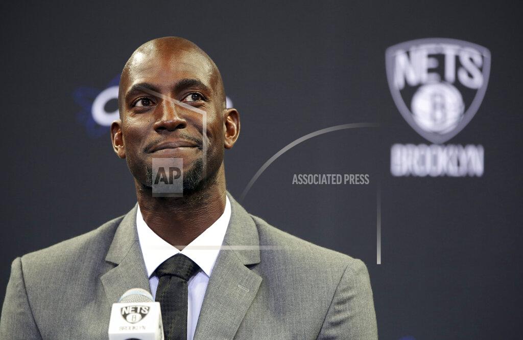 Mary Altaffer FILE - In this July 18, 2013 file photo, Kevin Garnett smiles as he speaks to reporters during an NBA basketball news conference in New York. Garnett and fellow NBA greats Tim Duncan and Kobe Bryant headlined a nine-person group announced Saturday, April 4, 2020, as this year’s class of enshrinees into the Naismith Memorial Basketball Hall of Fame. They all got into the Hall in their first year of eligibility, as did WNBA great Tamika Catchings. Two-time NBA champion coach Rudy Tomjanovich, longtime Baylor women’s coach Kim Mulkey, 1,000-game winner Barbara Stevens of Bentley and three-time Final Four coach Eddie Sutton were selected. So was former FIBA Secretary General Patrick Baumann. (AP Photo/Mary Altaffer, File)