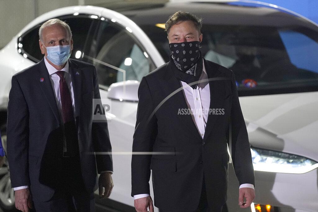 John Raoux NASA acting administrator Steve Jurczyk, left and SpaceX founder and CEO Elon Musk arrive for the walkout of the SpaceX crew before a launch attempt Friday, April 23, 2021, at the Kennedy Space Center in Cape Canaveral, Fla. Four astronauts will fly on the SpaceX Crew mission to the International Space Station scheduled for launch on April 23, 2021. (AP Photo/John Raoux)
