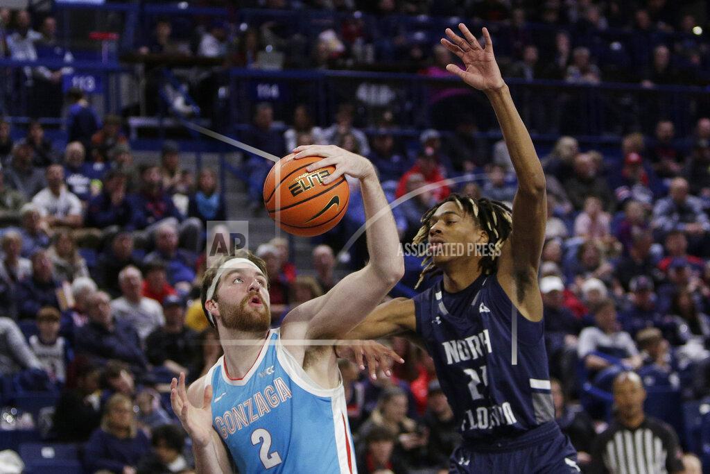 Young Kwak Gonzaga forward Drew Timme (2) drives to the basket while defended by North Florida forward Jadyn Parker (24) during the second half of an NCAA college basketball game, Monday, Nov. 7, 2022, in Spokane, Wash. Gonzaga won 104-63. (AP Photo/Young Kwak)