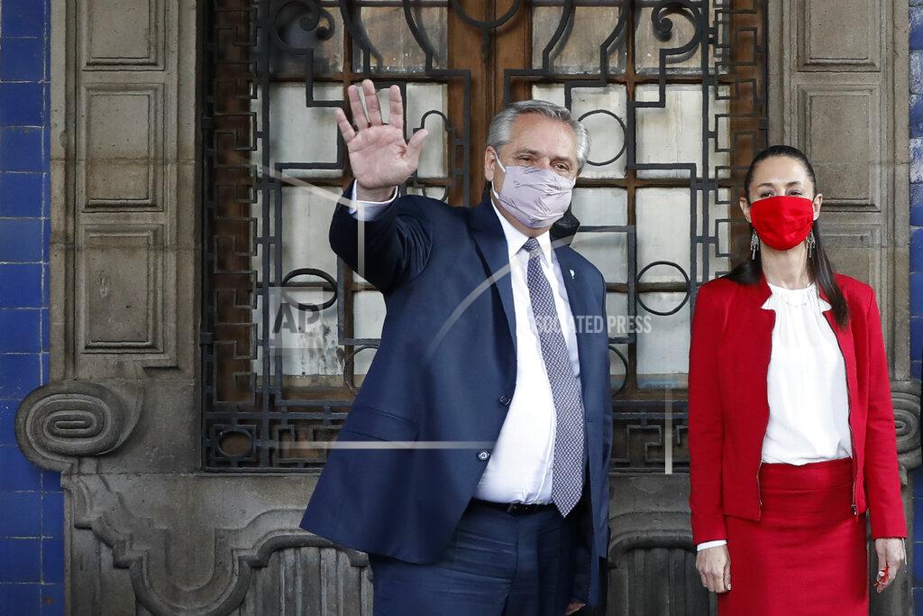 Rebecca Blackwell Argentine President Alberto Fernandez waves as he leaves the Old Town Hall with Mexico City Mayor Claudia Sheinbaum, in Mexico City, Tuesday, Feb. 23, 2021. Fernandez is on an official visit to Mexico.(AP Photo/Rebecca Blackwell)
