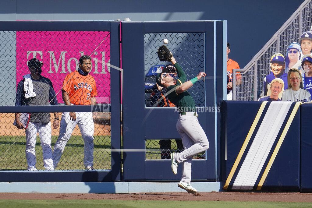 Marcio Jose Sanchez Oakland Athletics right fielder Mark Canha catches Houston Astros' Aledmys Diaz's fly out during the sixth inning of Game 3 of a baseball American League Division Series in Los Angeles, Wednesday, Oct. 7, 2020. (AP Photo/Marcio Jose Sanchez)