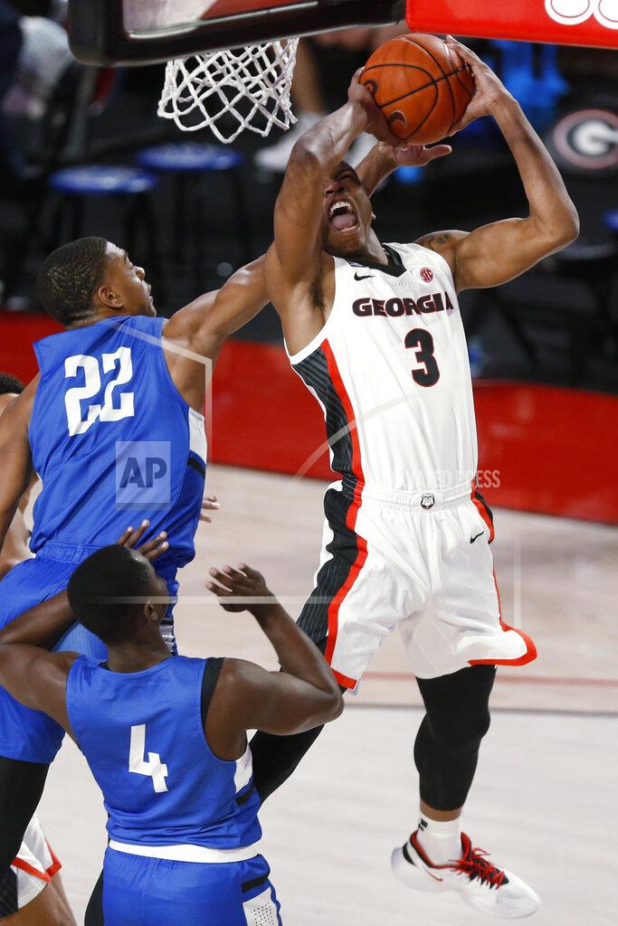 Joshua L. Jones Georgia's Christian Brown (3) shoots while being defended by North Georgia forward Eric Jones (22) during an NCAA college basketball game in Athens, Ga., Wednesday, Dec. 2, 2020. (Joshua L. Jones/Athens Banner-Herald via AP)