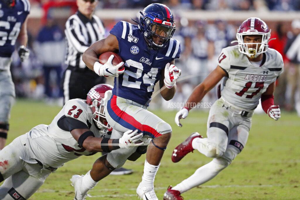 Rogelio V. Solis Mississippi running back Snoop Conner (24) runs through the hands of New Mexico State linebacker Rashie Hodge Jr. (23) on his way to a first down during the second half of an NCAA college football game in Oxford, Miss., Saturday, Nov. 9, 2019. Mississippi won 41-3. (AP Photo/Rogelio V. Solis)