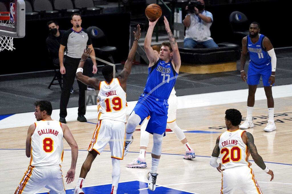 Tony Gutierrez Atlanta Hawks' Danilo Gallinari (8), Tony Snell (19) and John Collins (20) defend as Dallas Mavericks' Luka Doncic (77) goes up to sink a shot late in the second half of an NBA basketball game in Dallas, Wednesday, Feb. 10, 2021. (AP Photo/Tony Gutierrez)