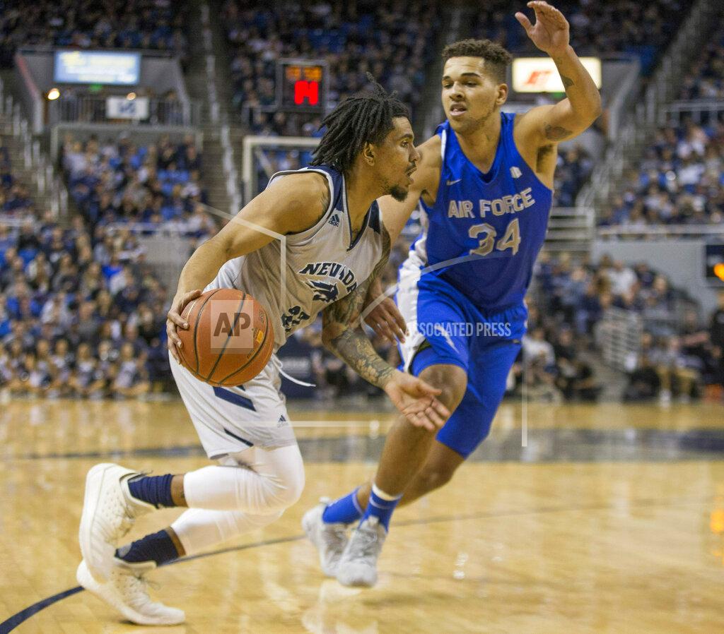 Tom R. Smedes Nevada guard Jazz Johnson (22) drives the baseline against Air Force forward Ryan Swan (34) during the first half of an NCAA college basketball game in Reno, Nev., Saturday, Jan. 19, 2019. (AP Photo/Tom R. Smedes)