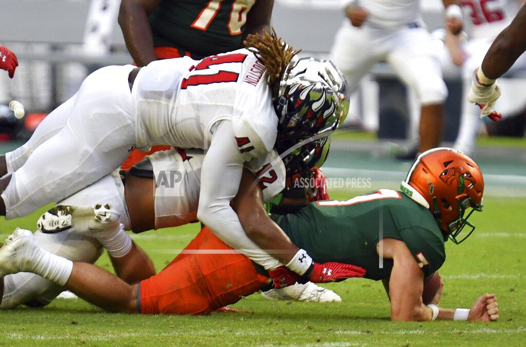 Jim Rassol Florida A&M quarterback Junior Muratovic (7) is tackled by Jackson State defensive back Cam'Ron Silmon (12) and linebacker James Houston IV (41) on fourth down late in the fourth quarter of an NCAA college football game, Sunday, Sept. 5, 2021, in Miami Gardens, Fla. (AP Photo/Jim Rassol)