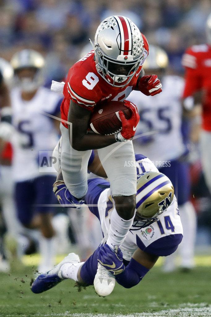 Marcio Jose Sanchez Ohio State wide receiver Binjimen Victor is tackled by Washington defensive back JoJo McIntosh during the first half of the Rose Bowl NCAA college football game Tuesday, Jan. 1, 2019, in Pasadena, Calif. (AP Photo/Marcio Jose Sanchez)