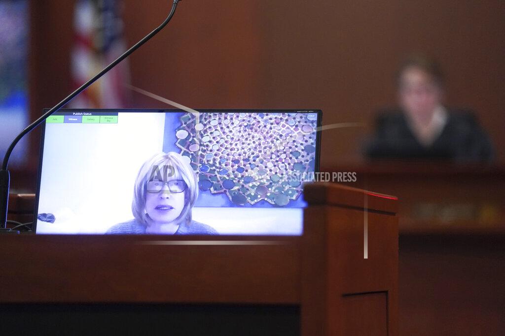 Shaw Thew Tracey Jacobs testifies in a previously recorded video deposition in the courtroom at the Fairfax County Circuit Courthouse in Fairfax, Va., Thursday, May 19, 2022. Actor Johnny Depp sued his ex-wife Amber Heard for libel in Fairfax County Circuit Court after she wrote an op-ed piece in The Washington Post in 2018 referring to herself as a "public figure representing domestic abuse." (Shawn Thew/Pool photo via AP)