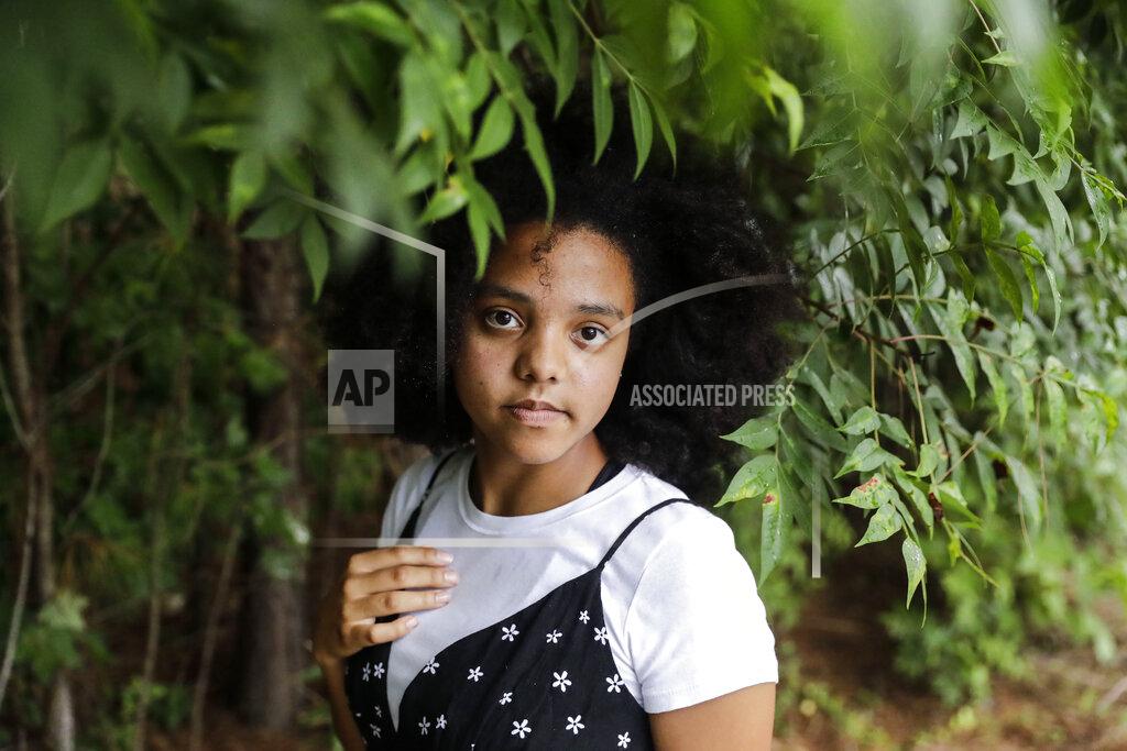 Brynn Anderson Gabby Bashizi, 17, poses for a portrait on Friday, July 24, 2020, in Marietta, Ga. Bashizi was one of thousands of teenagers who plotted on the social media site TikTok to reserve tickets to Trump's rally in Tulsa in June, then not show up. (AP Photo/Brynn Anderson)
