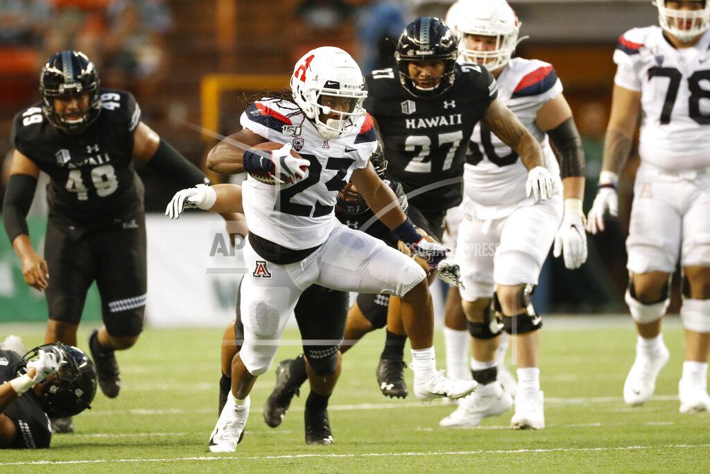 Marco Garcia Arizona running back Gary Brightwell (23) runs through the Hawaii defense during an NCAA college football game, Saturday, Aug. 24, 2019, in Honolulu. (AP Photo/Marco Garcia)