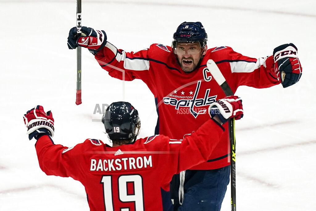 Alex Brandon Washington Capitals left wing Alex Ovechkin (8) and center Nicklas Backstrom (19) celebrate after a goal during the second period of Game 1 of an NHL hockey Stanley Cup first-round playoff series against the Boston Bruins, Saturday, May 15, 2021, in Washington. It was later determined that the goal was scored by Capitals defenseman Brenden Dillon. (AP Photo/Alex Brandon)