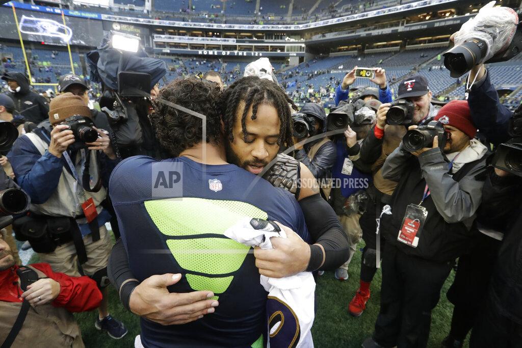 Elaine Thompson Seattle Seahawks quarterback Russell Wilson, left, hugs Baltimore Ravens free safety Earl Thomas, right, after they traded jerseys following an NFL football game, Sunday, Oct. 20, 2019, in Seattle. (AP Photo/Elaine Thompson)