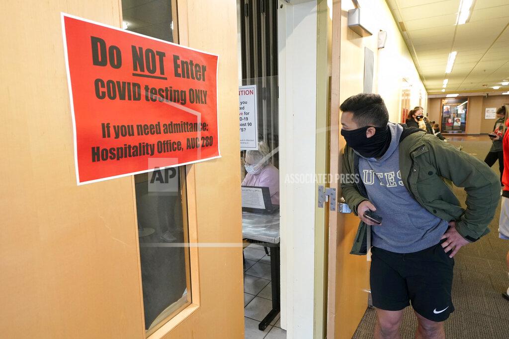 Ted S. Warren Josef Triman, a senior defensive back at Pacific Lutheran, waits in line to take a three-times-a-week COVID-19 test Monday, Feb. 1, 2021, in Tacoma, Wash. Like the big programs that played in the fall, testing, distancing and protective equipment have topped the priority list in trying to pull off a season. (AP Photo/Ted S. Warren)