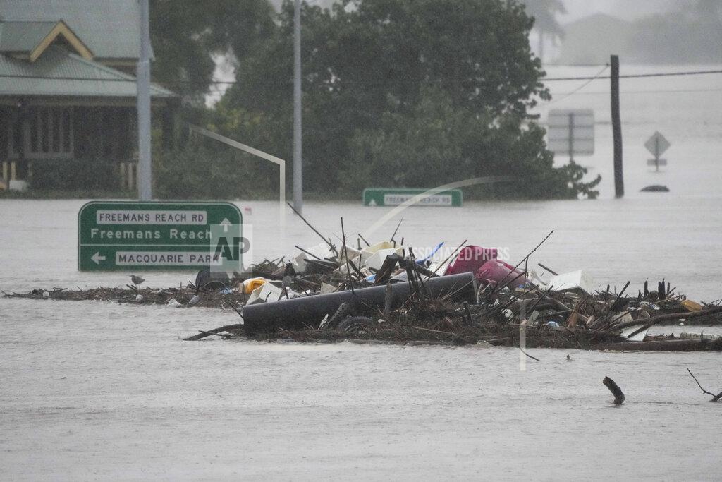 Mark Baker Debris sits in the middle of the flooded Windsor Bridge on the outskirts of Sydney, Australia, Monday, July 4, 2022. More than 30,000 residents of Sydney and its surrounds have been told to evacuate or prepare to abandon their homes on Monday as Australia's largest city braces for what could be its worst flooding in 18 months. (AP Photo/Mark Baker)