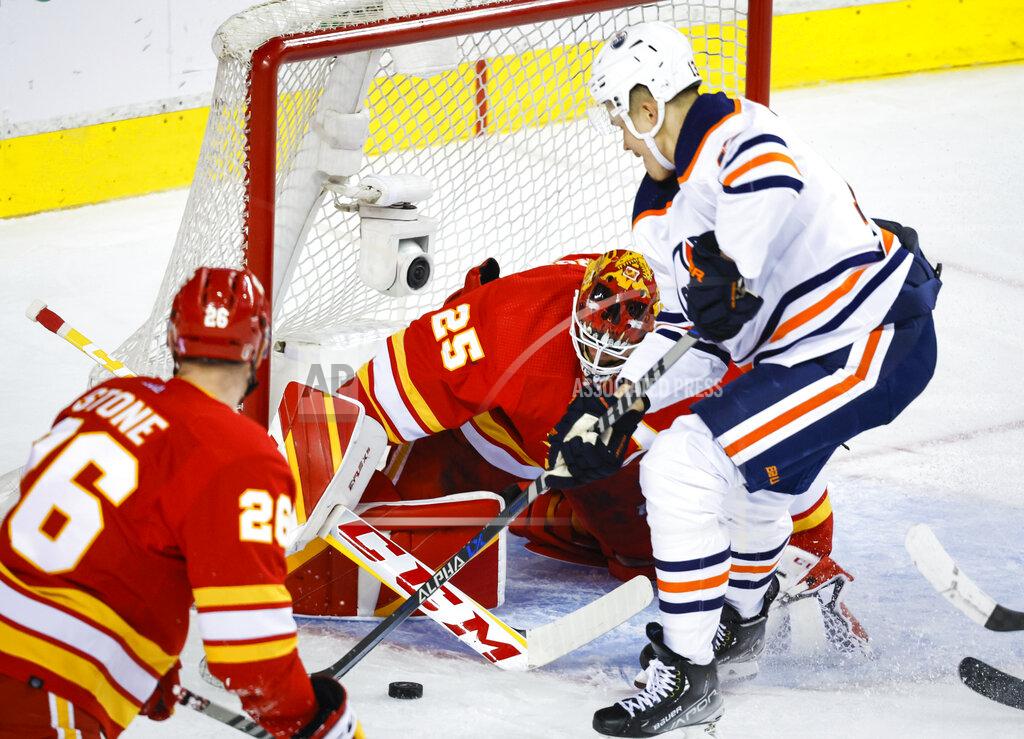 Jeff Mcintosh Edmonton Oilers winger Jesse Puljujarvi, right, has the net blocked by Calgary Flames goalie Jacob Markstrom during the second period of Game 5 of an NHL hockey second-round playoff series Thursday, May 26, 2022, in Calgary, Alberta. (Jeff McIntosh/The Canadian Press via AP)