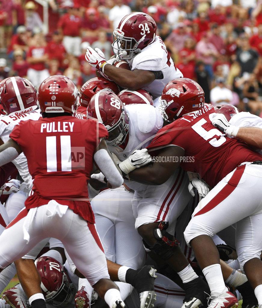 Michael Woods Alabama running back Damien Harris, top, pushes the ball over the goal line to score a touchdown against Arkansas in the second half of an NCAA college football game Saturday, Oct. 6, 2018, in Fayetteville, Ark. (AP Photo/Michael Woods)