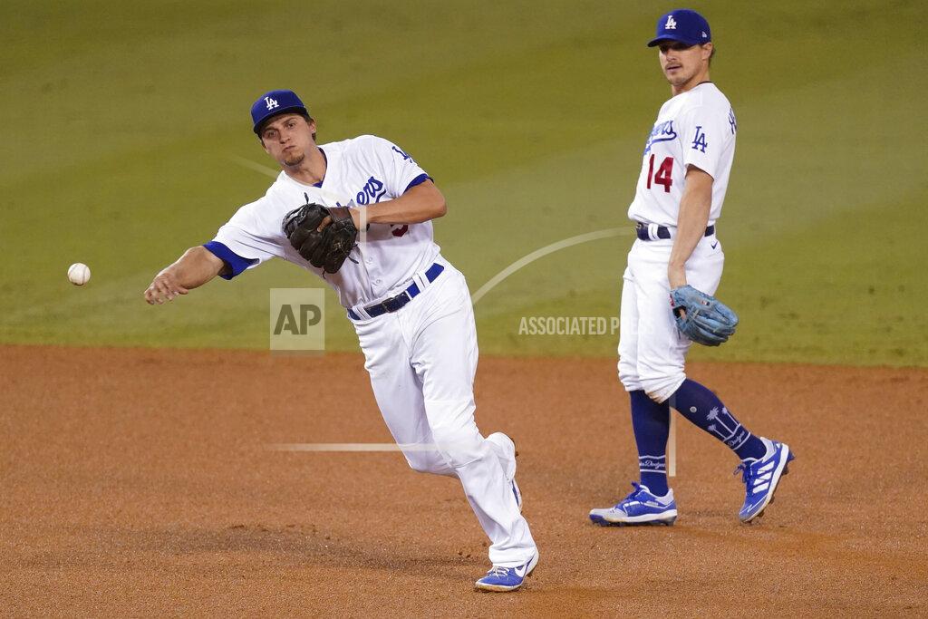 Ashley Landis Los Angeles Dodgers shortstop Corey Seager throws to first to put out Los Angeles Angels' Albert Pujols during the fifth inning of a baseball game Friday, Sept. 25, 2020, in Los Angeles. Second baseman Enrique Hernandez is at right. (AP Photo/Ashley Landis)