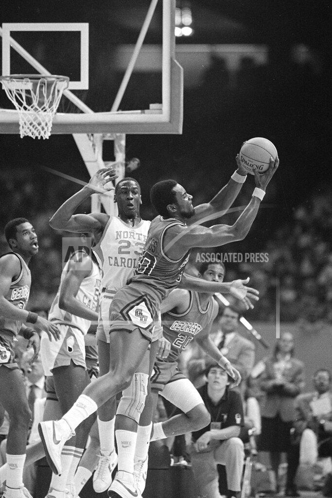Anonymous FILE - In this March 29, 2020, file photo, Georgetown's Ed Springs takes a rebound away from North Carolina's Michael Jordan (23) during the NCAA championship at the Superdome in New Orleans. Jordan scored 16 points, including the game-winning shot with 15 seconds left. North Carolina beat Georgetown 63-62. (AP Photo/File)