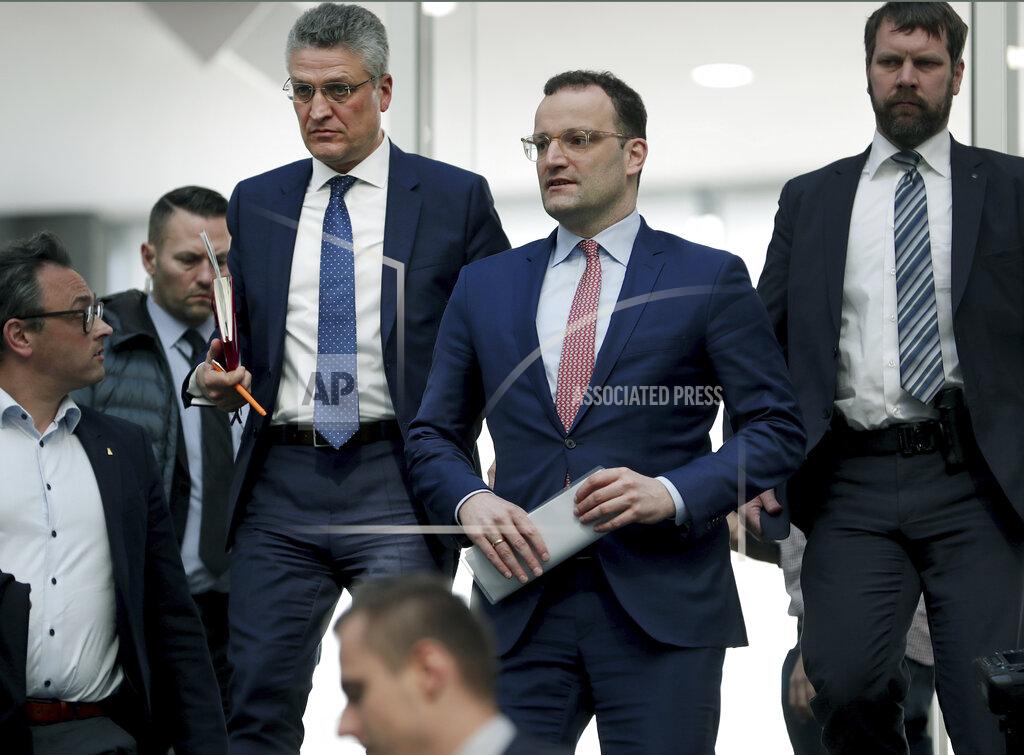 Michael Sohn File - In this Thursday, March 26, 2020 file photo, Lothar H. Wieler, president of the Robert-Koch-Institute, top left, and German Health Minister Jens Spahn of the Christian Democratic Union, CDU, party, top center, leave after a press conference in Berlin, Germany, on the fight against the new coronavirus outbreak. German Chancellor Angela Merkel's center-right party, the Christian Democratic Union, CDU, is choosing a new leader on the weekend Saturday Jan. 16 and Sunday Jan. 17, 2021, a decision that will help determine who succeeds Merkel at the helm of the European Union's biggest economy after a 16-year reign. (AP Photo/Michael Sohn, file)