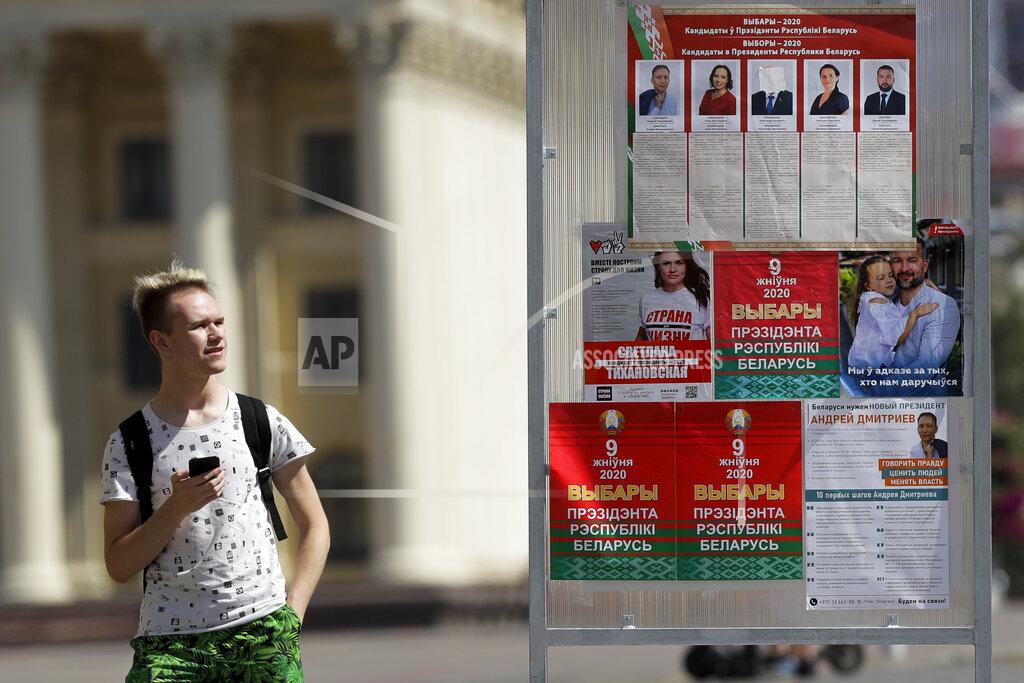 Sergei Grits A man looks at a billboard on the street with portraits of presidential candidates with the Belarus President Alexander Lukashenko's face covered with a white sticky tape ahead of Sunday's election in Minsk, Belarus, Tuesday, Aug. 4, 2020. Belarus's authoritarian leader is vowing to maintain a close alliance with Russia despite the latest tensions as he seeks a sixth term in office amid a surge of opposition protests. President Alexander Lukashenko's comments in a state-of-the-nation address ahead of Sunday's election contrast with his diatribes against Russia last week. (AP Photo/Sergei Grits)