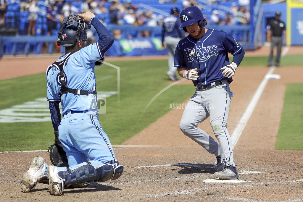 Mike Carlson Tampa Bay Rays' Brett Phillips, right, scores on a walk to Manuel Margot in front of Toronto Blue Jays catcher Danny Jansen during the ninth inning of a baseball game Sunday, May 23, 2021, in Dunedin, Fla. (AP Photo/Mike Carlson)