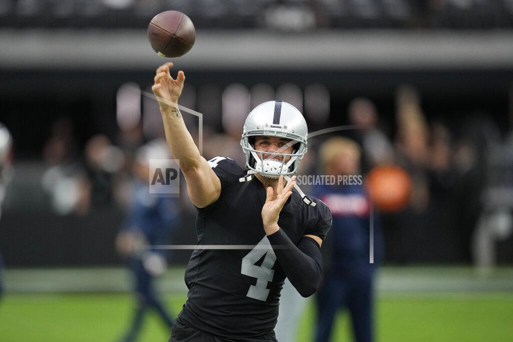 Las Vegas Raiders quarterback Derek Carr (4) warms up before an NFL preseason football game against the New England Patriots, Friday, Aug. 26, 2022, in Las Vegas. (AP Photo/John Locher)