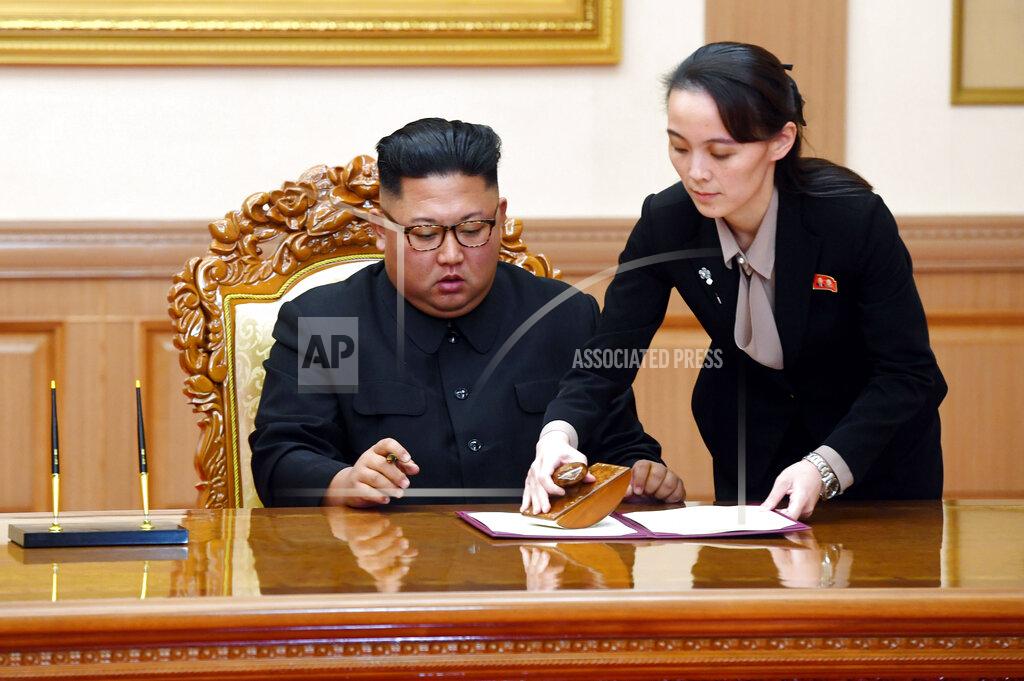 Uncredited FILE - In this Sept. 19, 2018, file photo, Kim Yo Jong, right, helps her brother North Korean leader Kim Jong Un sign a joint statement following the summit with South Korean President Moon Jae-in at the Paekhwawon State Guesthouse in Pyongyang, North Korea. In a closed-door briefing to South Korean lawmakers on Thursday, Aug. 20, 2020, Seoul's spy agency said the stress of managing state affairs caused Kim to recently delegate some of his powers to a select group of senior officials, including his sister Kim Yo Jong, who is now chiefly involved in shaping policies toward Washington and Seoul. (Pyongyang Press Corps Pool via AP, File)