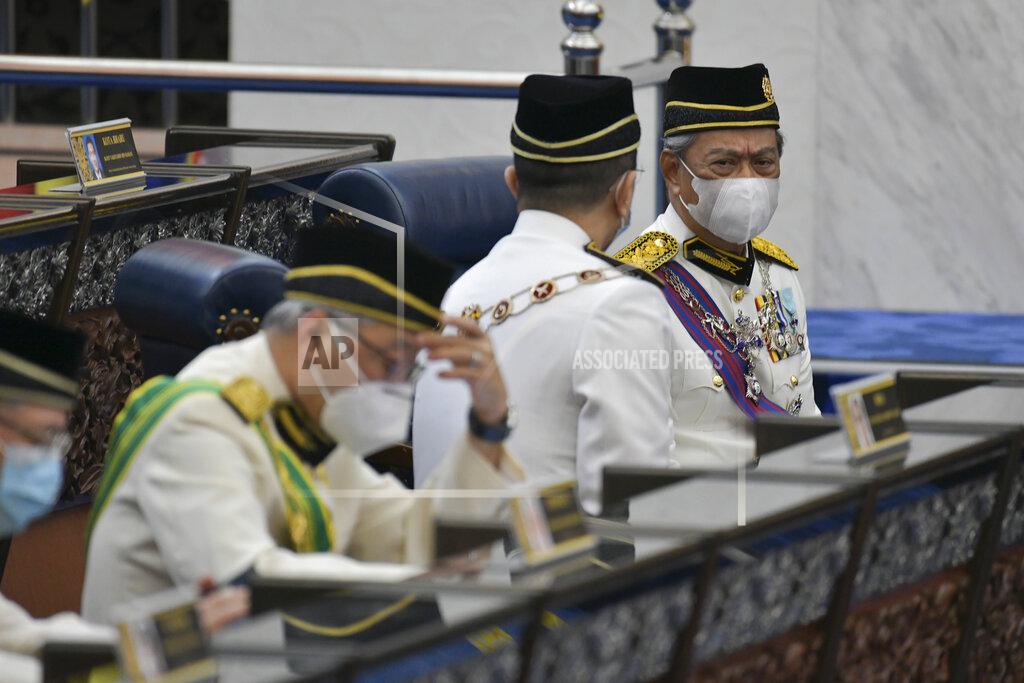 Nazri Rapai In this photo released by Malaysia's Department of Information, Malaysia's Prime Minister Muhyiddin Yassin, right, wearing a face mask along with his cabinet members attend the opening ceremony of the third term of the 14th parliamentary session at parliament house in Kuala Lumpur Monday, May 18, 2020. Malaysia's parliament held an unusual half-day sitting Monday, that was kept short due to the COVID-19 pandemic and saw Prime Minister Muhyiddin Yassin dodge a vote of no-confidence against him over two months since he came into power. (Nazri Rapai/Malaysia's Department of Information via AP)