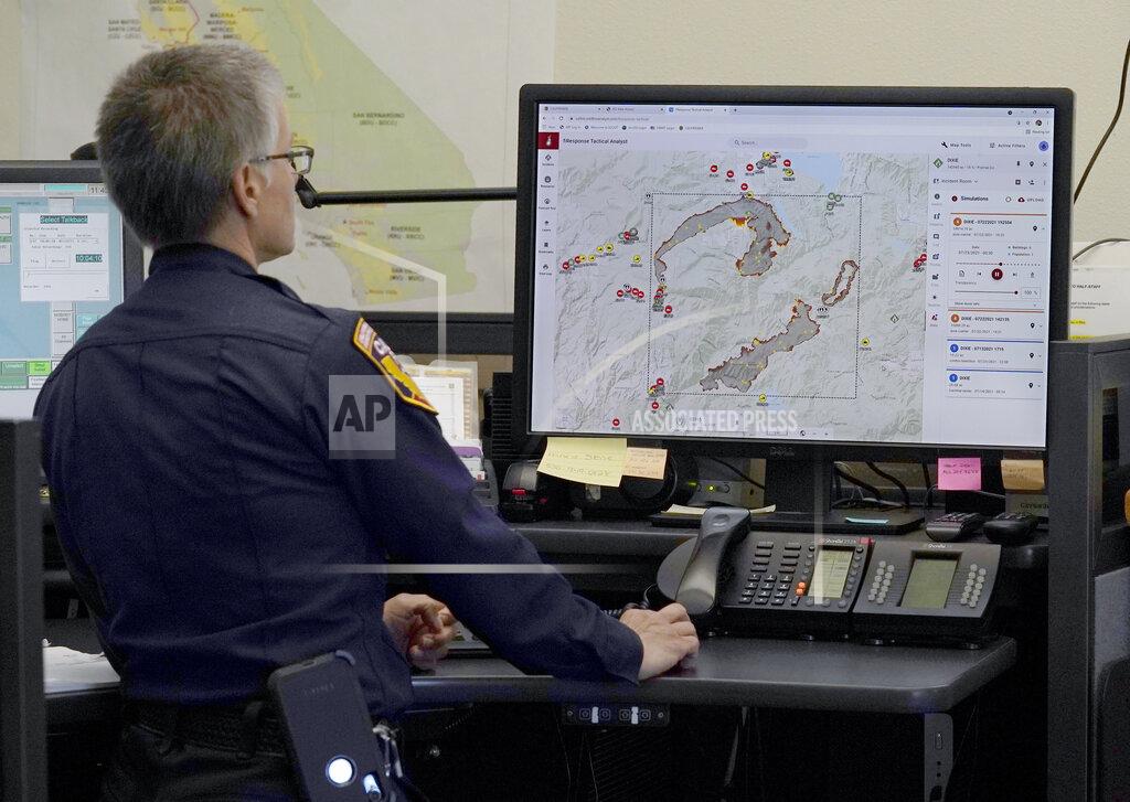 Rich Pedroncelli CORRECTS SPELLING OF FIRST NAME TO DANELL, NOT DANELLE - Cal Fire Capt. Danell Eshnaur uses the Fire Response Tactical Analyst program to use computer modeling to help pre-position fire fighting resources on the Dixie Fire at the California Department of Forestry and Fire Protection's Sacramento Command Center in Rancho Cordova, Calif., Friday, July 23, 2021. Firefighters are trying to become smarter in how they prepare for the drought- and wind-driven wildfires that have become more dangerous across the American West in recent years, including by using new technology like fire behavior computer modeling that can help assess risks before fires start, then project their path and growth. (AP Photo/Rich Pedroncelli)