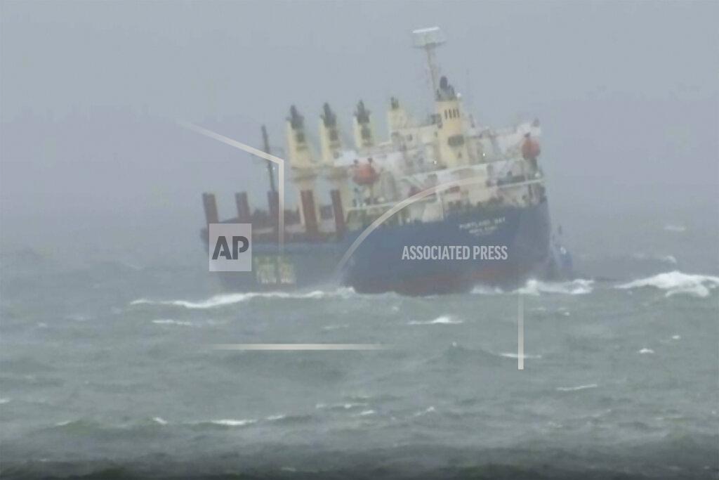 Uncredited In this image taken from video shows a stranded cargo ship off Wollongong, Australia, Monday, July 4, 2022. A cargo ship that left the Australian port of Wollongong on Monday morning has lost power and is drifting at sea south of Sydney with 21 crew on board. According to local media, the ship is now anchored near the coast and a tugboat is on location to try and prevent it from getting closer to nearby cliffs and rocks. (Australian Broadcasting Corporation via AP)