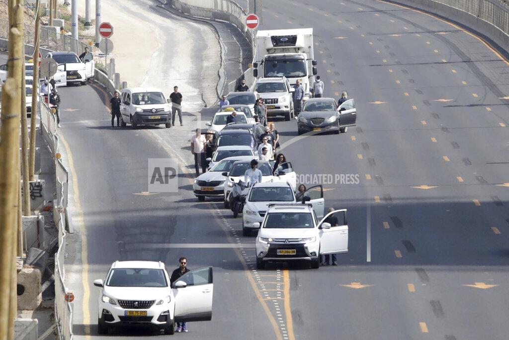 Sebastian Scheiner Israelis stand next to their cars as sirens mark a nationwide moment of silence in remembrance of the 6 million Jewish victims of the Holocaust, in Tel Aviv, Israel, Thursday, April 8, 2021. (AP Photo/Sebastian Scheiner)