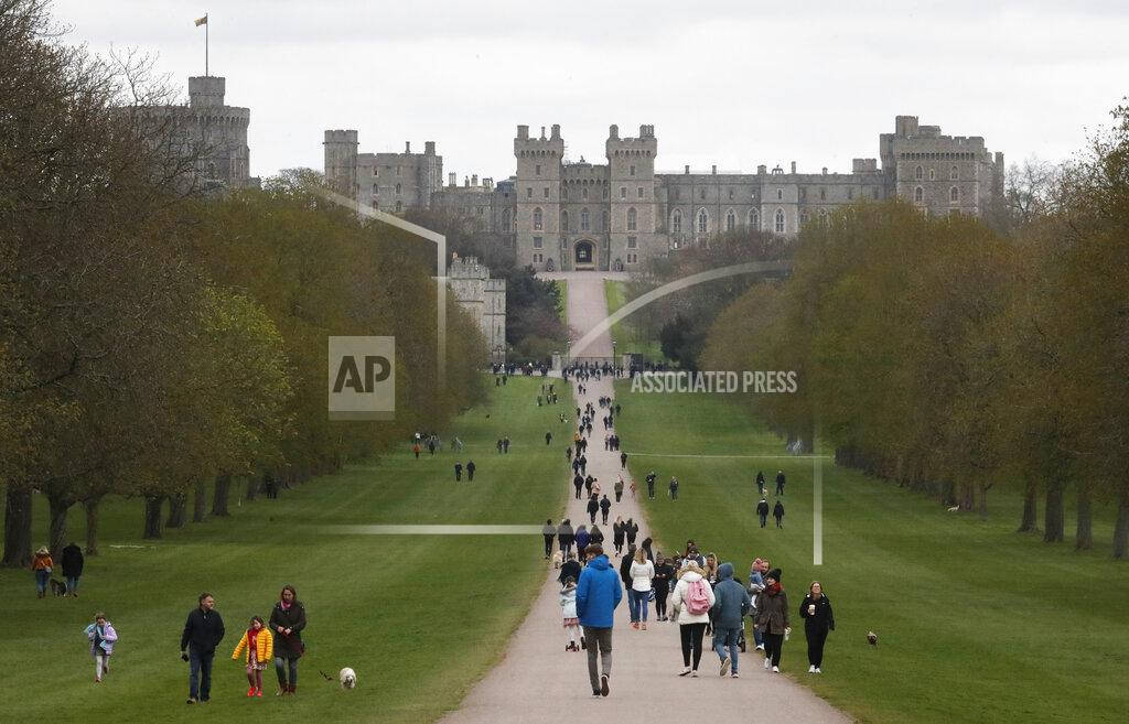 Frank Augstein People stroll on The Long Walk towards Windsor Castle in Windsor, England, Saturday, April 10, 2021. Britain's Prince Philip, the irascible and tough-minded husband of Queen Elizabeth II who spent more than seven decades supporting his wife in a role that mostly defined his life, died on Friday. (AP Photo/Frank Augstein)