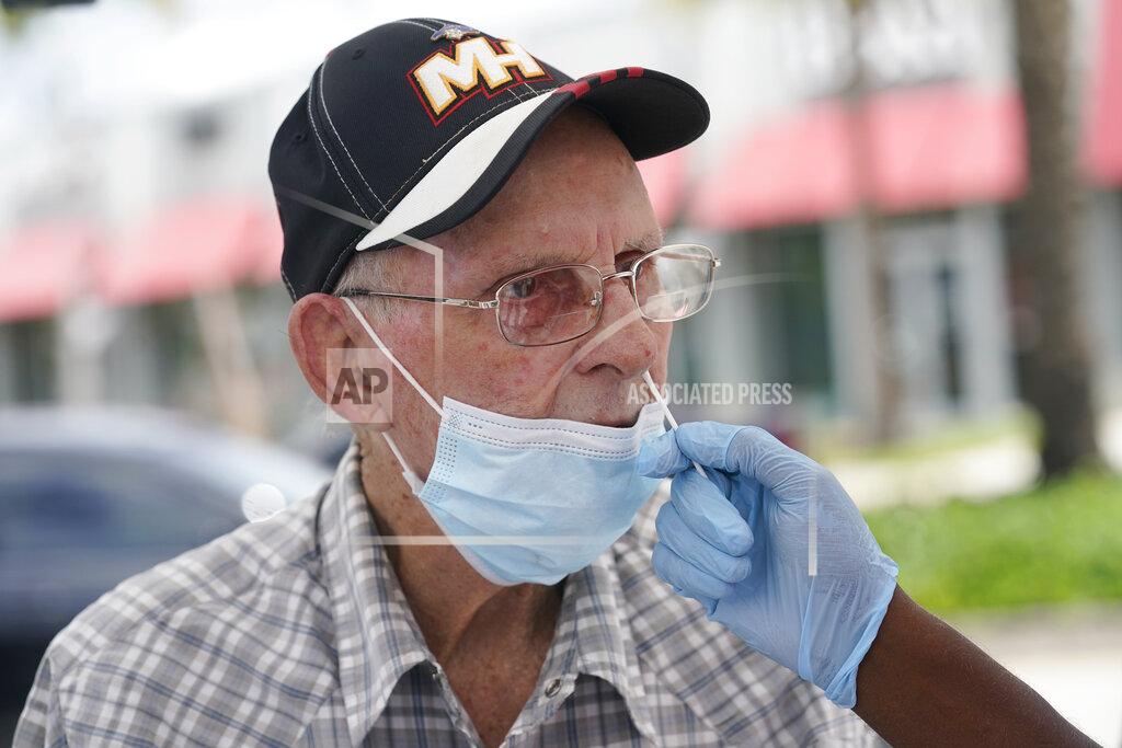 Marta Lavandier Alberto Rodriguez gets a COVID-19 rapid test, Monday, July 26, 2021, in Miami. Rodriguez needs a negative test to be able to visit his wife at a nursing home. Florida accounted for a fifth of the nation's new infections last week, more than any other state, according to the U.S. Centers for Disease Control and Prevention. (AP Photo/Marta Lavandier)