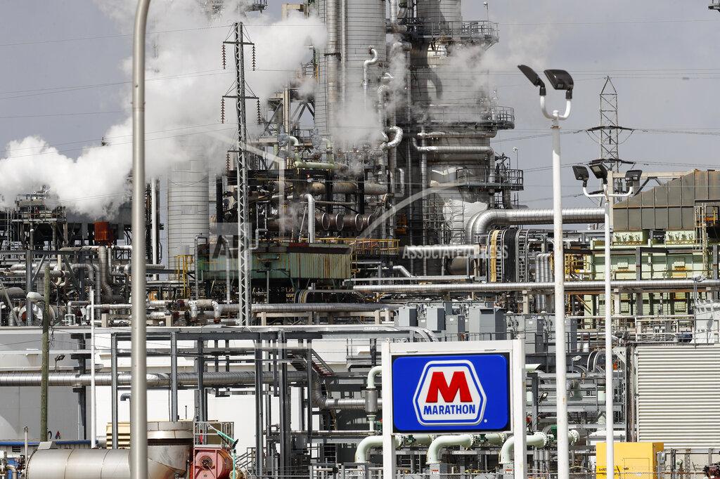 FILE - In this April 21, 2020, file photo the Marathon Petroleum Corp. refinery is shown in Detroit. Thousands of oil and gas operations, government facilities and other sites won permission to stop monitoring for hazardous emissions or otherwise bypass rules intended to protect health and the environment because of the coronavirus outbreak, The Associated Press has found. (AP Photo/Paul Sancya, File)