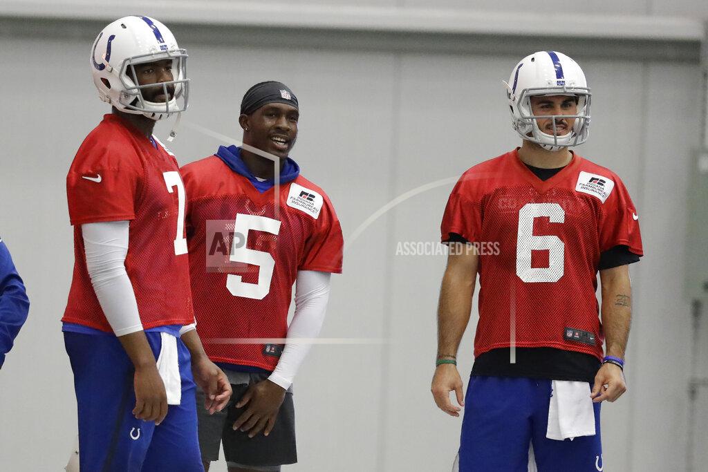 Darron Cummings Indianapolis Colts quarterbacks Jacoby Brissett (7), Phillip Walker (5) and Chad Kelly (6) watch during practice at the team's NFL football training facility, Monday, Aug. 26, 2019, in Indianapolis. (AP Photo/Darron Cummings)