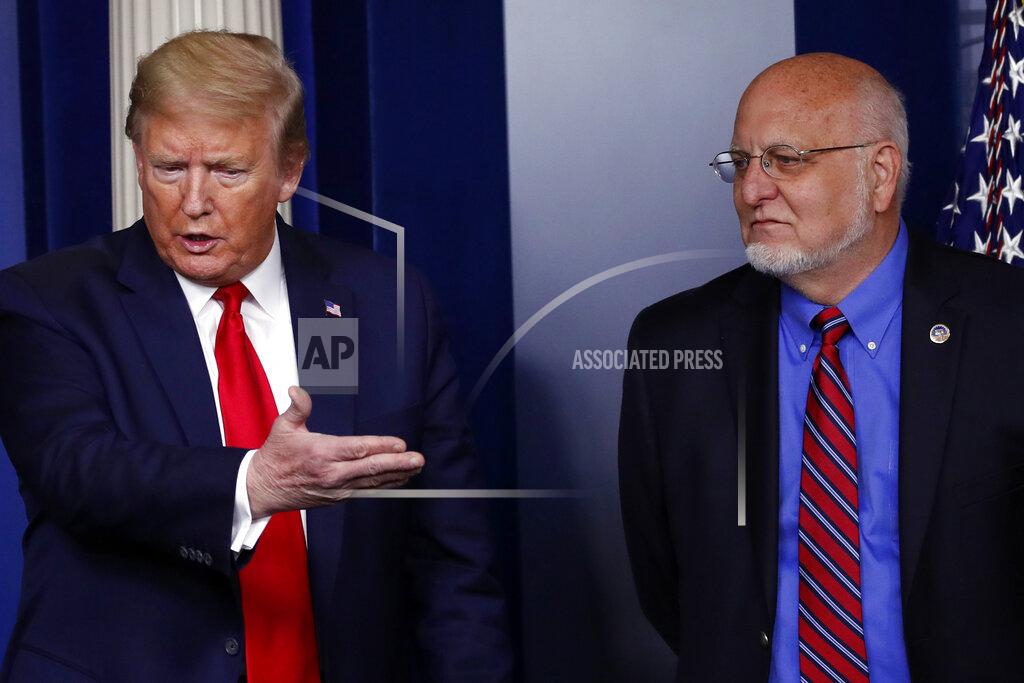 President Donald Trump speaks about the coronavirus in the James Brady Press Briefing Room of the White House, Wednesday, April 22, 2020, in Washington, as Dr. Robert Redfield, director of the Centers for Disease Control and Prevention, listens. (AP Photo/Alex Brandon)