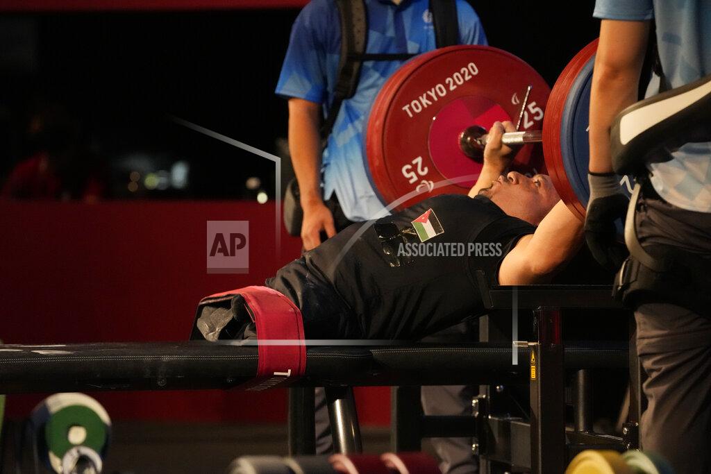 Kiichiro Sato FILE - In this Aug. 26, 2021, file photo, Jordan's Omar Sami Hamadeh Qarada prepares to lift during men's 49kg powerlifting final at the Tokyo 2020 Paralympic Games in Tokyo, Japan. Qarada won a gold medal in the event. There are 4,403 Paralympic athletes competing in Tokyo, each with unique differences that have to be classified. Lines have to be draw, in the quest for fairness, to group similar impairments, or impairments that yield similar results. (AP Photo/Kiichiro Sato, File)