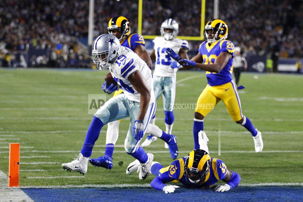 Jae C. Hong Dallas Cowboys wide receiver Amari Cooper, left, scores past Los Angeles Rams strong safety John Johnson during the first half in an NFL divisional football playoff game Saturday, Jan. 12, 2019, in Los Angeles. (AP Photo/Jae C. Hong)