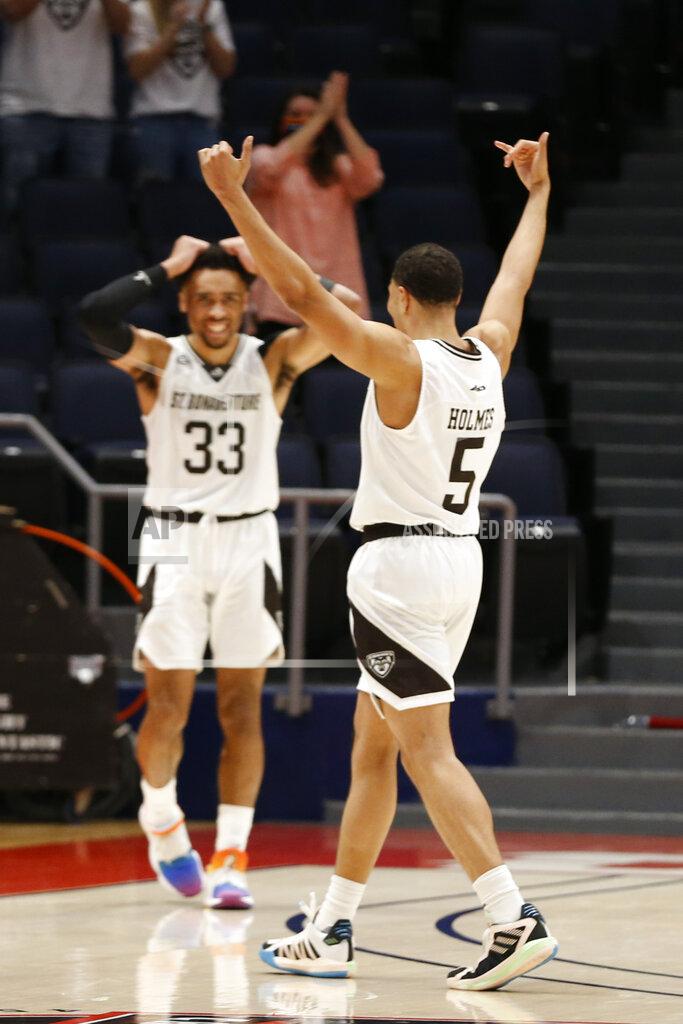 Jay Laprete FILE - St. Bonaventure's Jaren Holmes, right, and Jalen Adaway celebrate as time runs off the clock in their win over VCU in an NCAA college basketball game for the Atlantic Ten Conference championship Sunday, March 14, 2021, in Dayton, Ohio. St.No. 23 St. Bonaventure is ranked for the first time in 50 years and returns five seniors -- all starters -- from the team which went 16-5 and lost to eight-seeded LSU in the first round of the NCAA Tournament last year.(AP Photo/Jay LaPrete, FIle)
