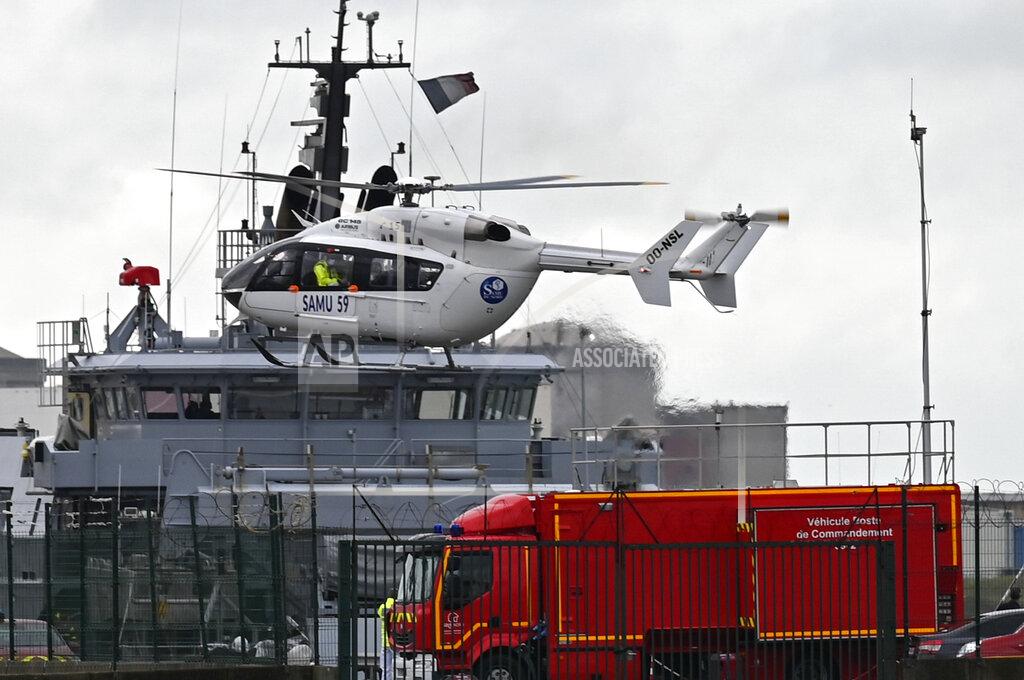 Uncredited A French rescue helicopter lands close to a rescue vessel in Dunkirk, northern France, Tuesday, Oct. 27, 2020 during a search operation after four migrants, including a 5-year-old and 8-year-old child died Tuesday when their boat capsized while they and other migrants tried to cross the English Channel to Britain, French authorities said. Fifteen migrants have been saved so far and rescue and search operations are still under way, according to the regional administration for the Nord region. (AP Photo)