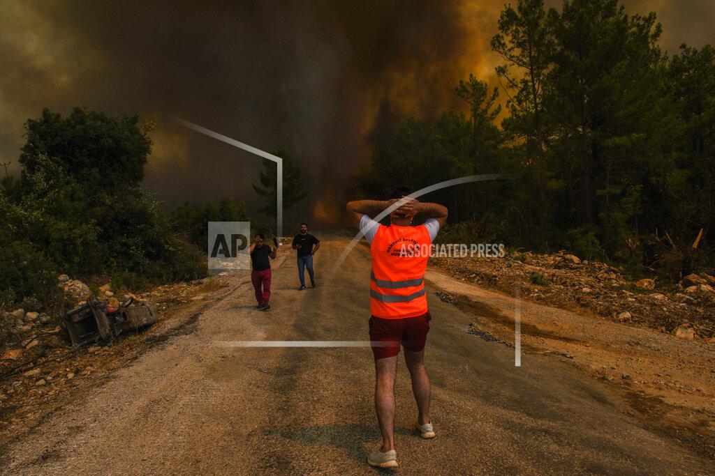 Uncredited FILE - In this Sunday, Aug. 1, 2021 file photo, people run away from the fire-devastated Sirtkoy village, near Manavgat, Antalya, Turkey. Scientists say there’s something different this year from the recent drumbeat of climate weirdness. This summer a lot of the places hit by weather disasters are not used to getting extremes and many of them are wealthier, which is different from the normal climate change victims. That includes unprecedented deadly flooding in Germany and Belgium, 116-degree heat records in Portland, Oregon and similar blistering temperatures in Canada, along with wildfires. Now Southern Europe is seeing scorching temperatures and out-of-control blazes too. And the summer of extremes is only getting started. Peak Atlantic hurricane and wildfire seasons in the United States are knocking at the door. (AP Photo, File)