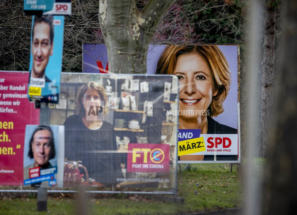 Michael Probst An election poster shows social democratic prime minister and top candidate for the Rhineland-Palatinate federal state elections Malu Dreyer, right, in Frankenthal, Germany, Wednesday, March 10, 2021. The elections will take place next Sunday. (AP Photo/Michael Probst)