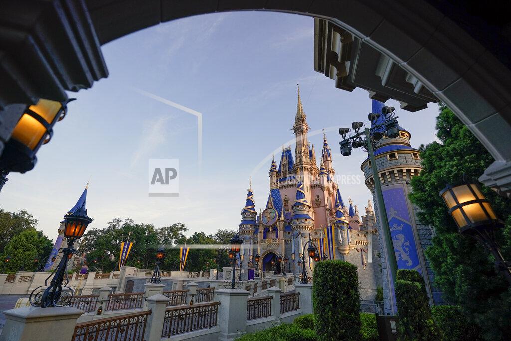 John Raoux The newly painted Cinderella Castle at the Magic Kingdom at Walt Disney World is seen with the the crest to celebrate the 50th anniversary of the theme park Monday, Aug. 30, 2021, in Lake Buena Vista, Fla. (AP Photo/John Raoux)